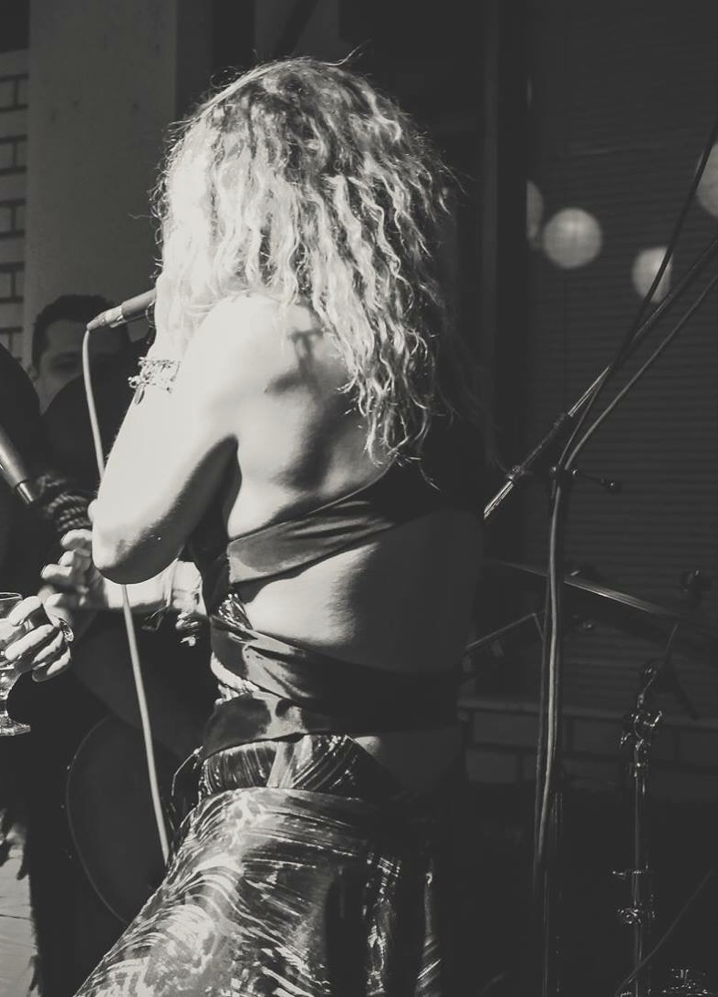 Dani Dimitrovska performing in a strapless dress
